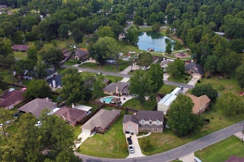 Aerial view of a Crosby, Texas neighborhood with homes and green trees, serviced by Affordable Plumbing Service.